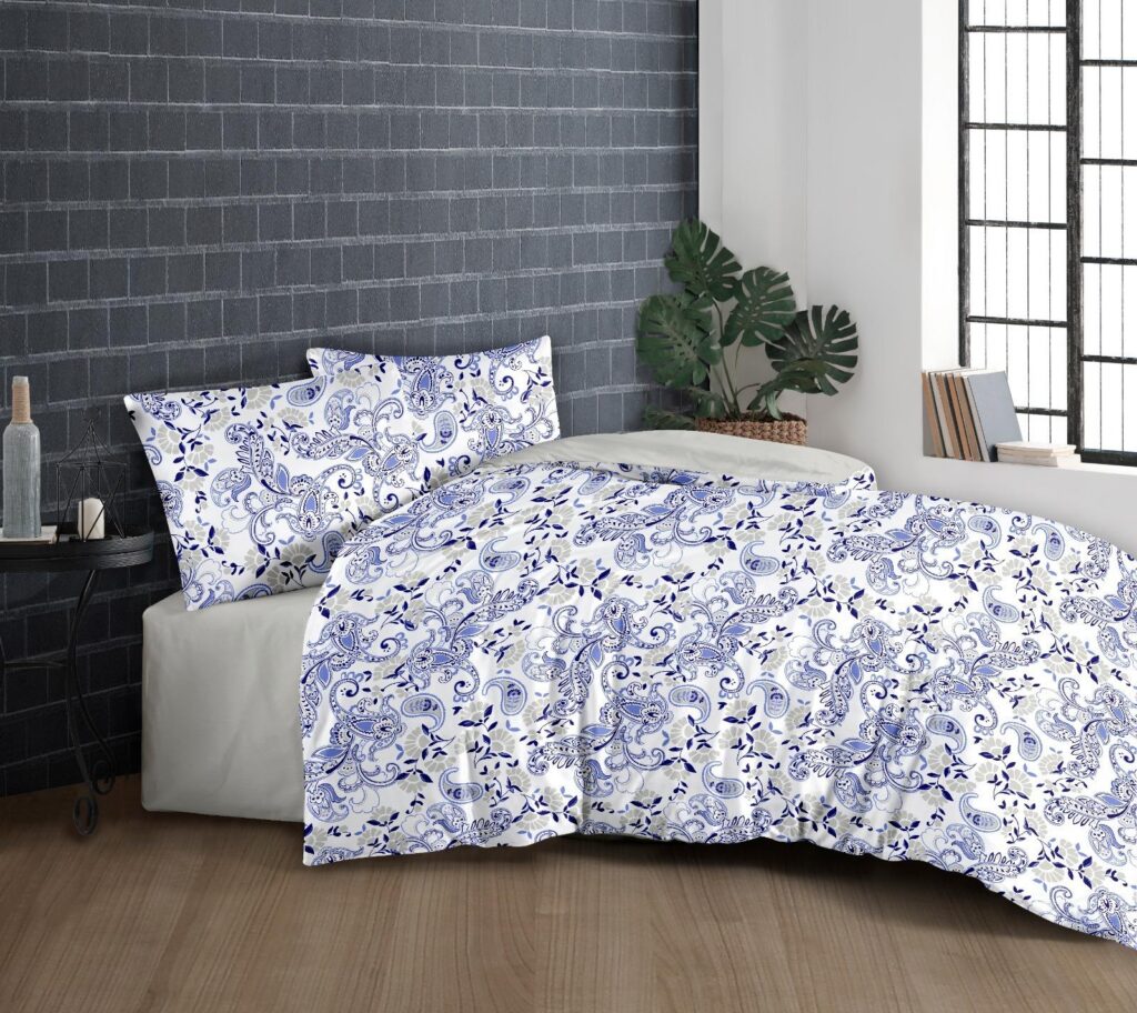 Navy floral and paisley bed linen set on a bed