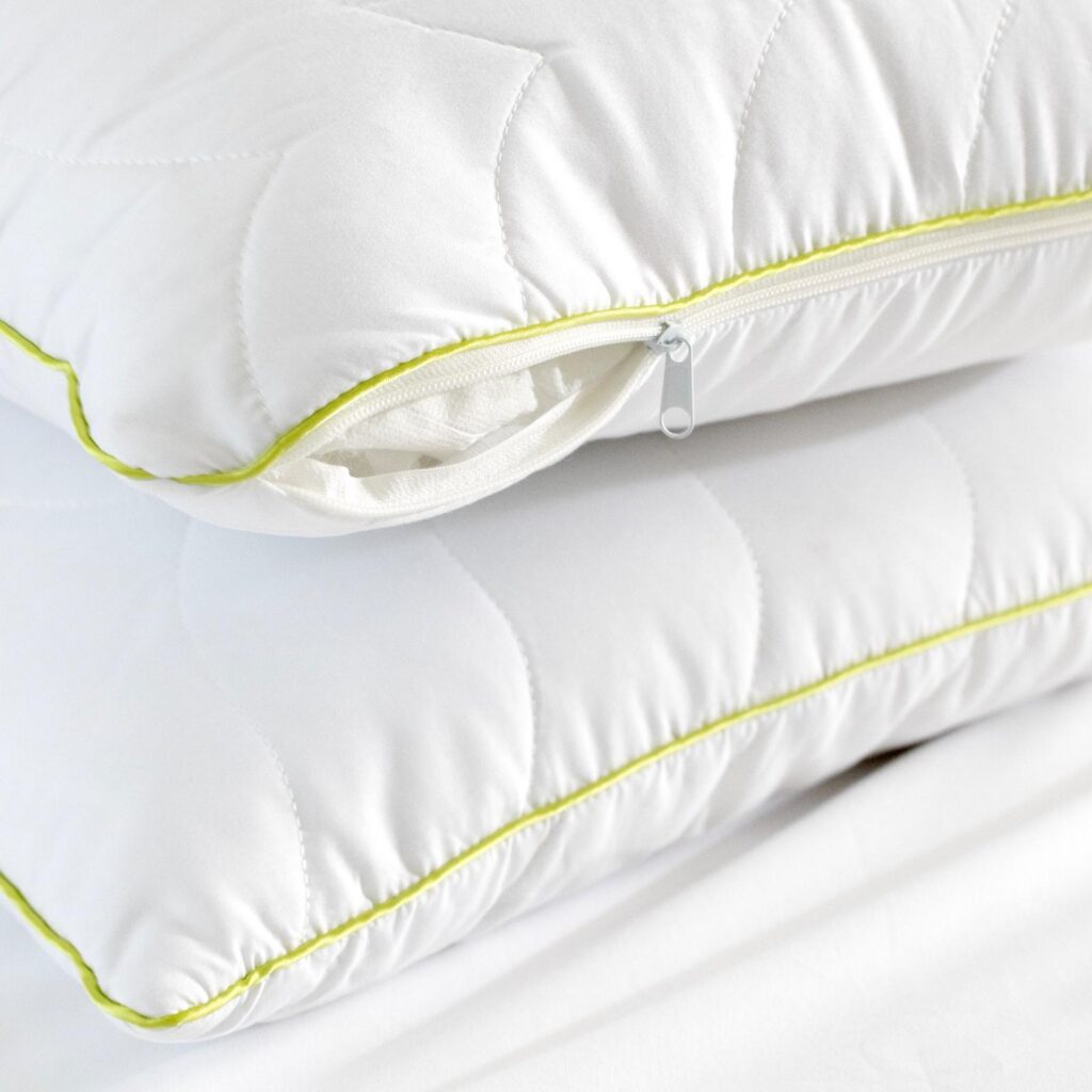 Close-up of a white pillow’s zip and piping seam