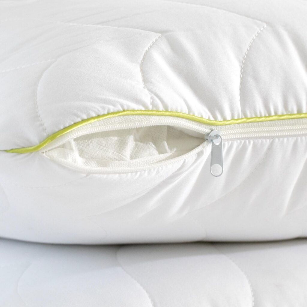 Close-up of a quilted pillow’s zip and piping detail